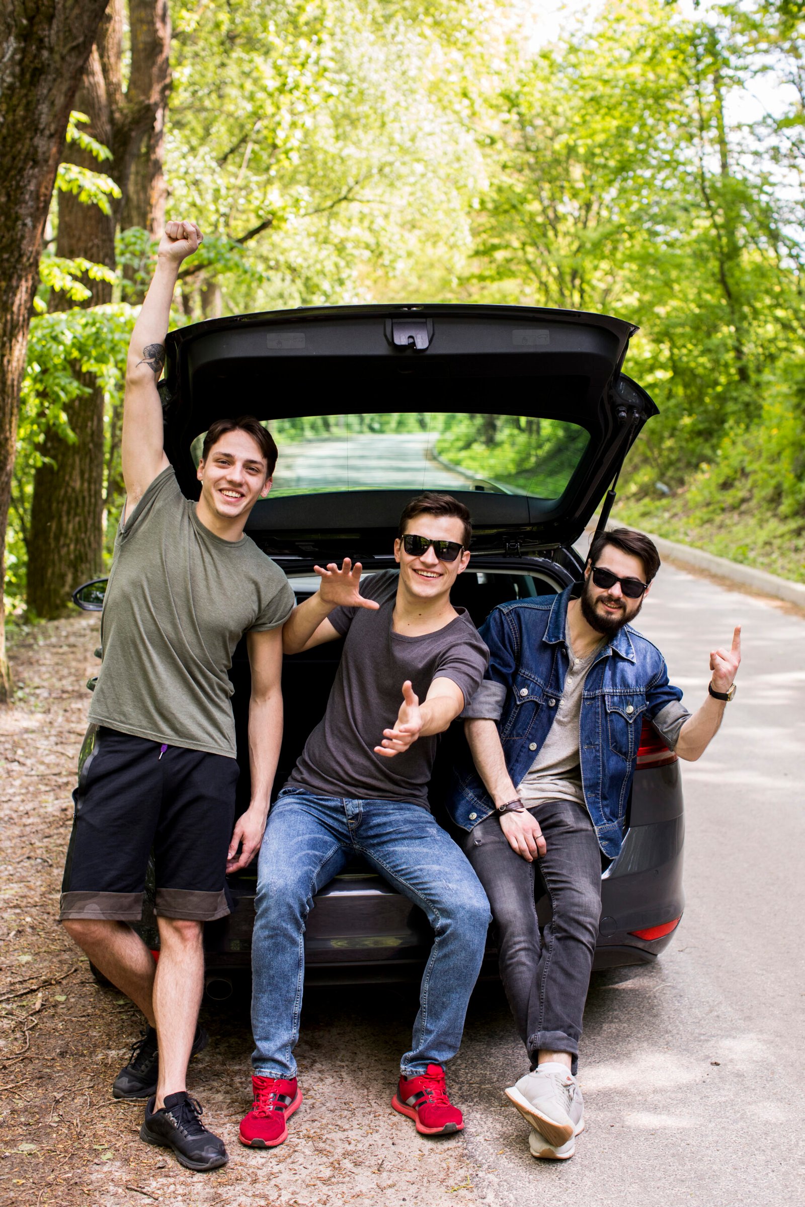happy-company-young-guys-sitting-trunk-travel